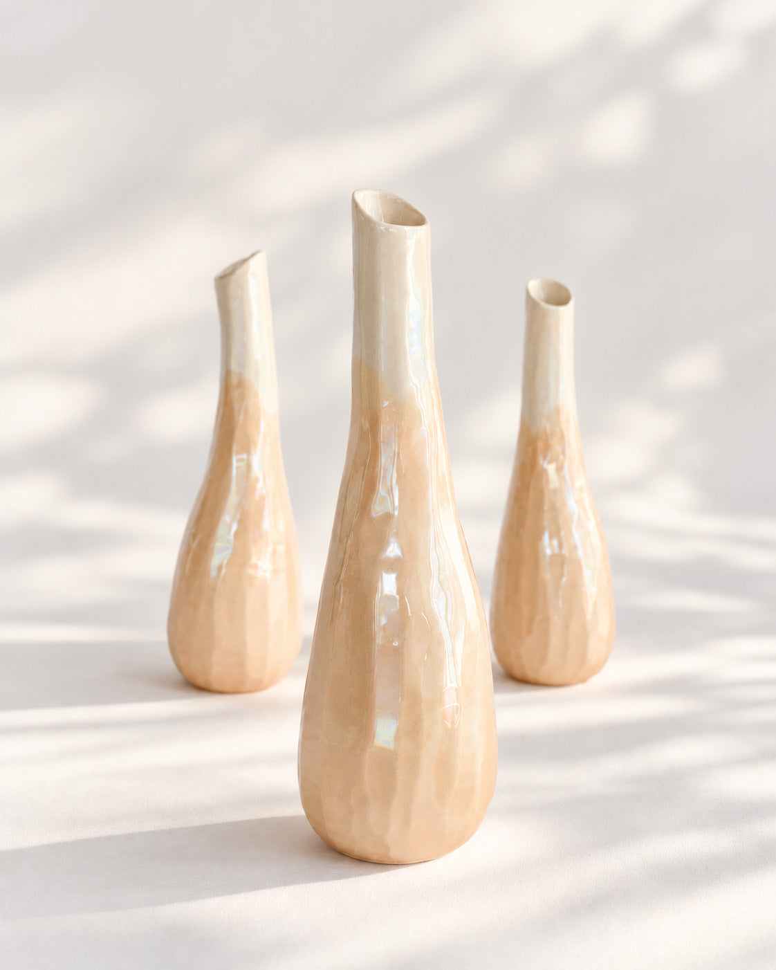 Three CALASSI AYA · ROSE vessels in pearly pink glaze, in soft light
